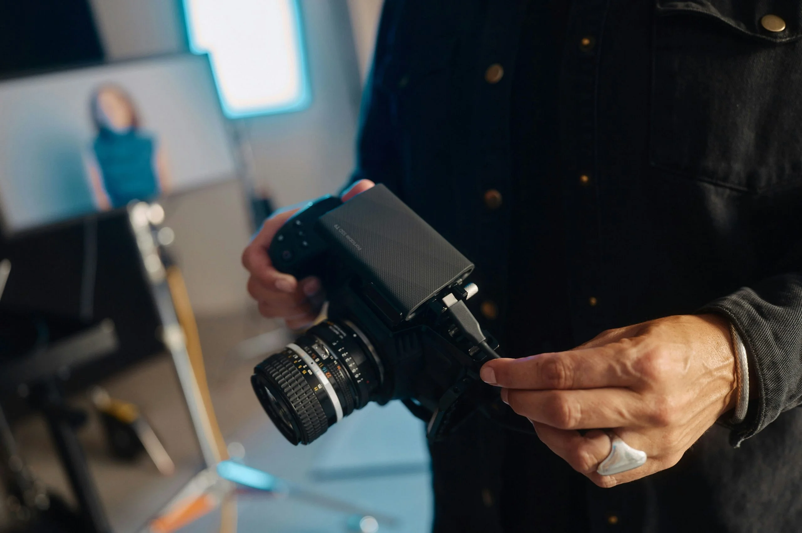 A man holding a camera in his hands scaled.jpg